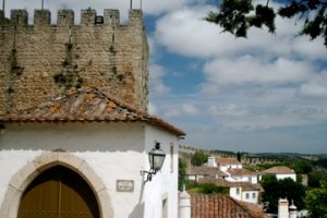 we are walking on the castle wall walkway around the city of Obidos